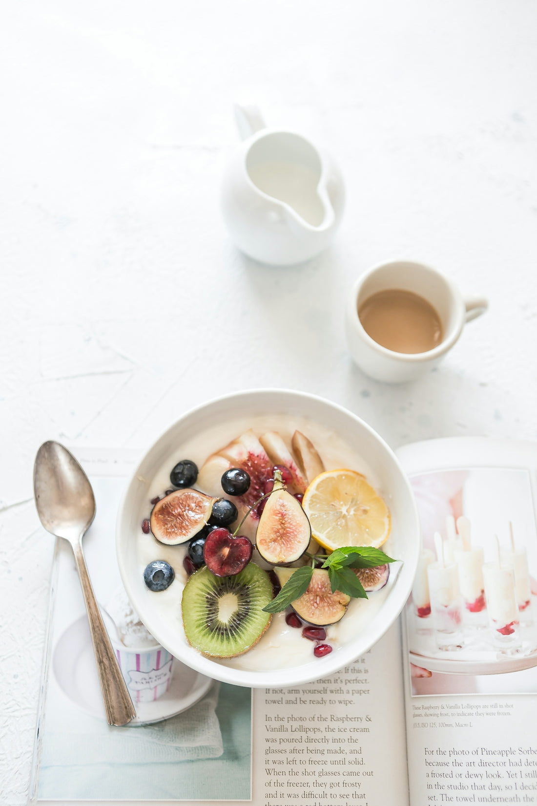 fruit yogurt bowl beside coffee cup